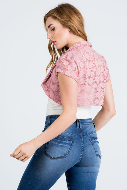 Crochet lace cropped shrug with open front and cap sleeves.