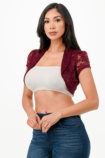 Crochet lace cropped shrug with open front and cap sleeves.