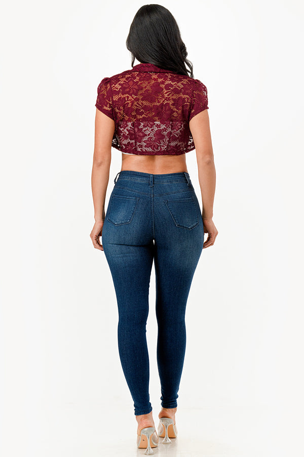 Crochet lace cropped shrug with open front and cap sleeves.