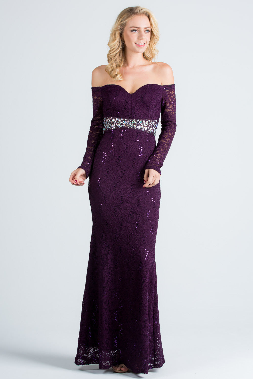 Off the shoulder long sleeve sweetheart sequin lace gown with waist embellishment.