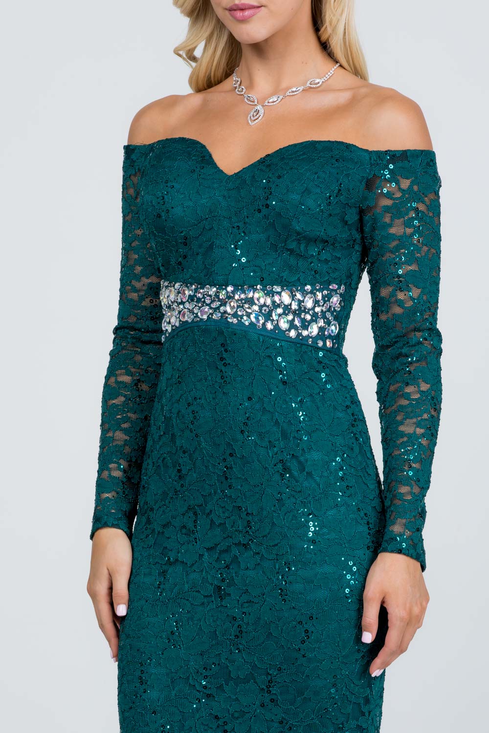 Off the shoulder long sleeve sweetheart sequin lace gown with waist embellishment.