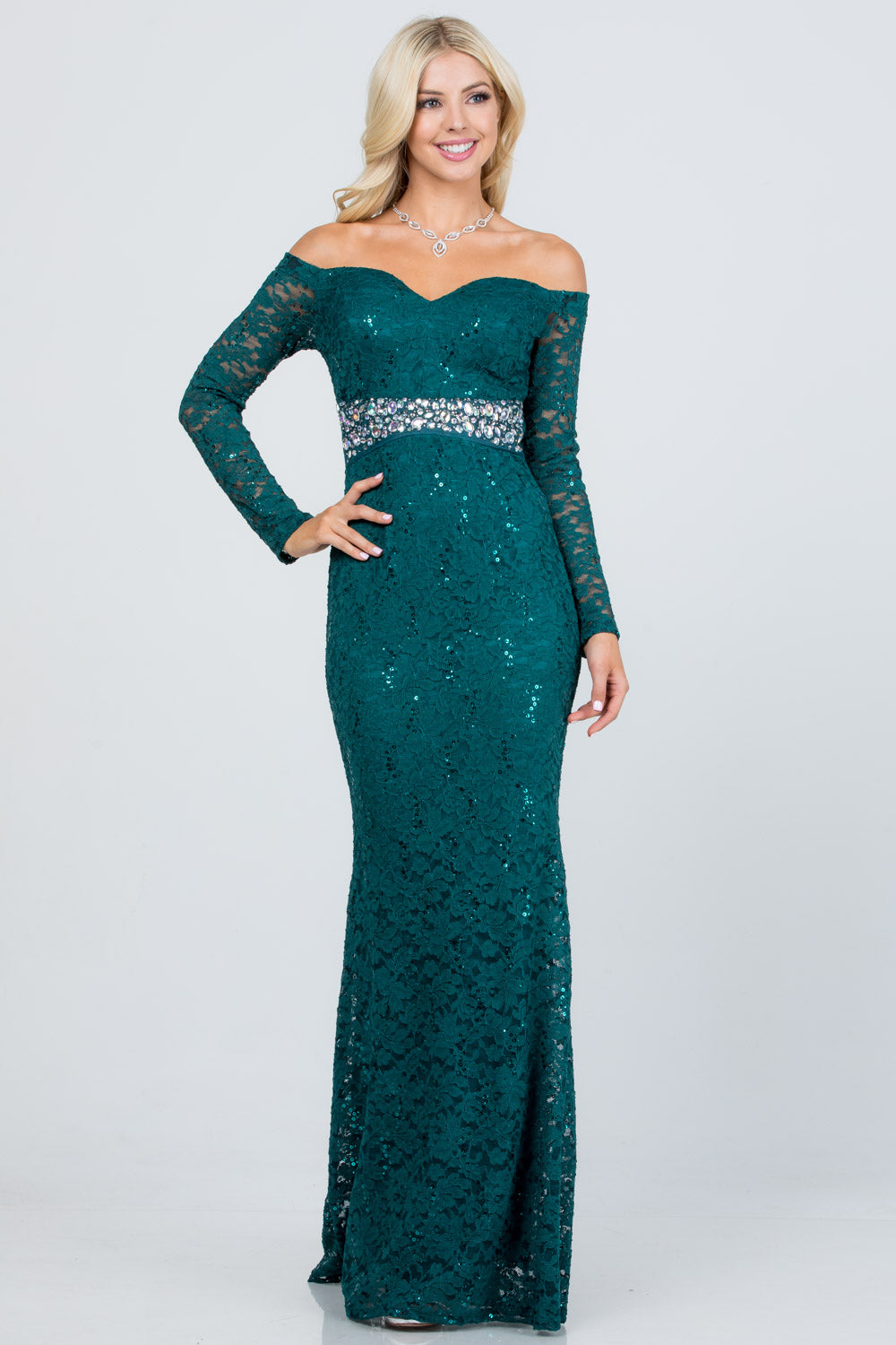 Off the shoulder long sleeve sweetheart sequin lace gown with waist embellishment.