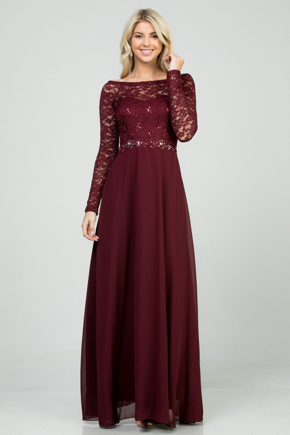 Long sleeve lace and chiffon A-line gown with waist lace embellishment.