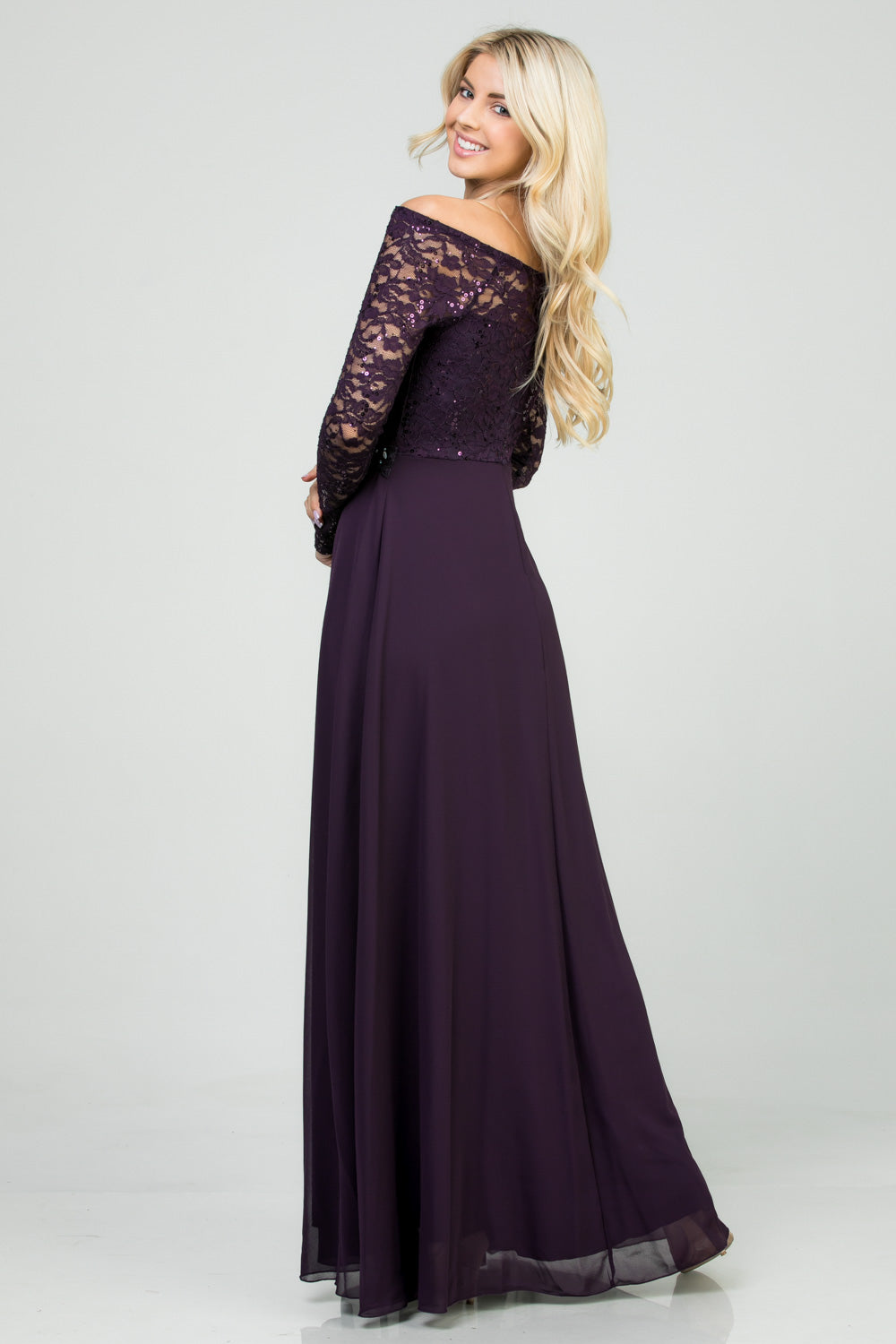 Long sleeve lace and chiffon A-line gown with waist lace embellishment.
