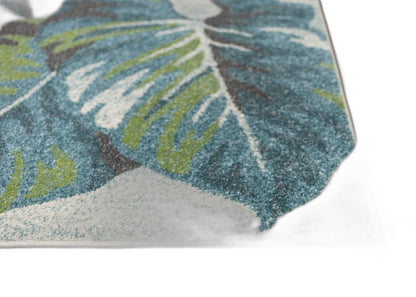 7' X 10' Beige Teal And Green Tropical Botanical Area Rug